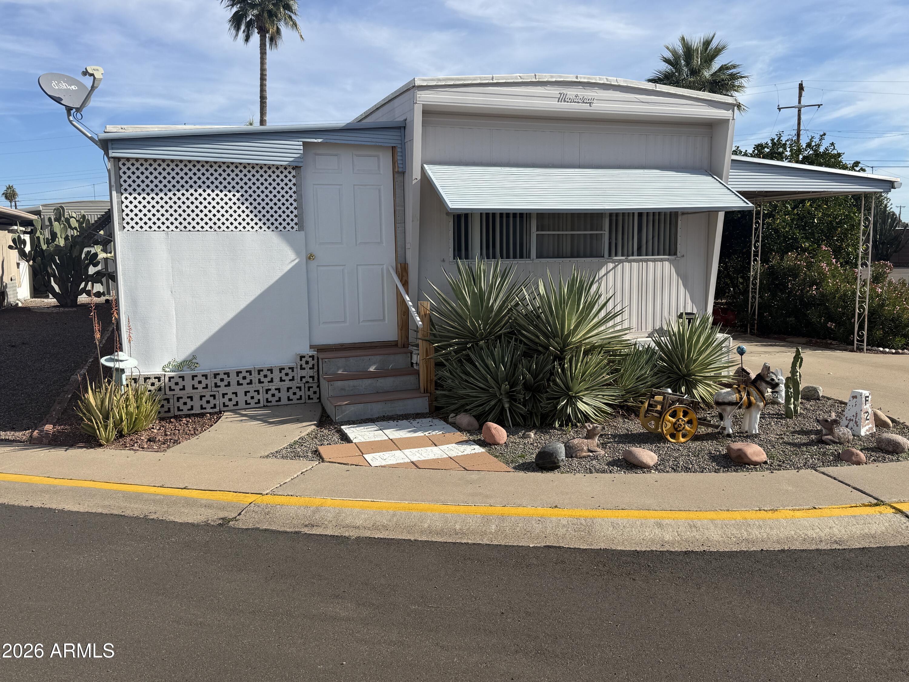 a view of swimming pool with outdoor seating and house in the background