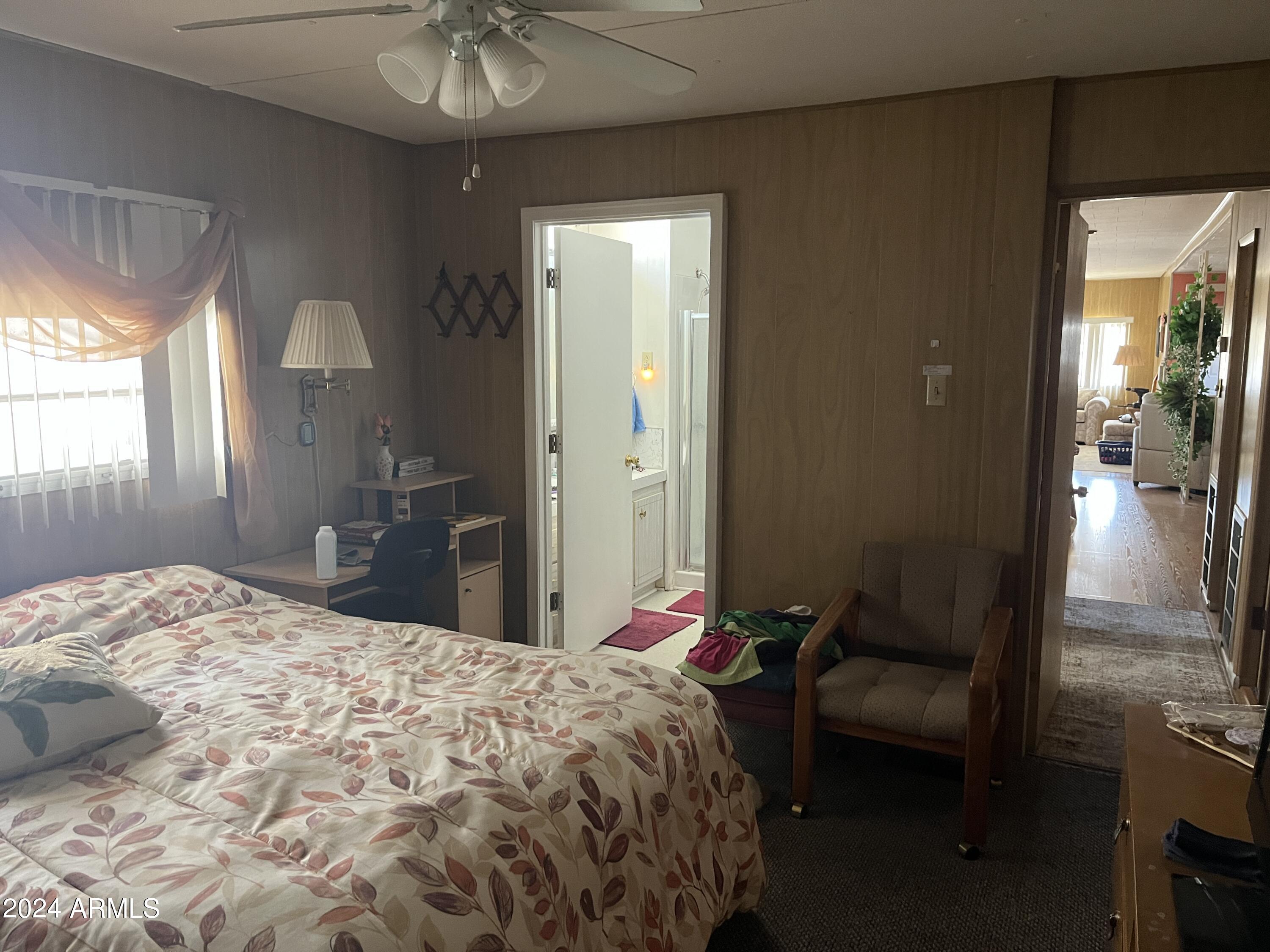 2460 East Main Street, Unit F2 Mesa, AZ 85213 - Photo 11 of 17 a bedroom with a bed and a chandelier