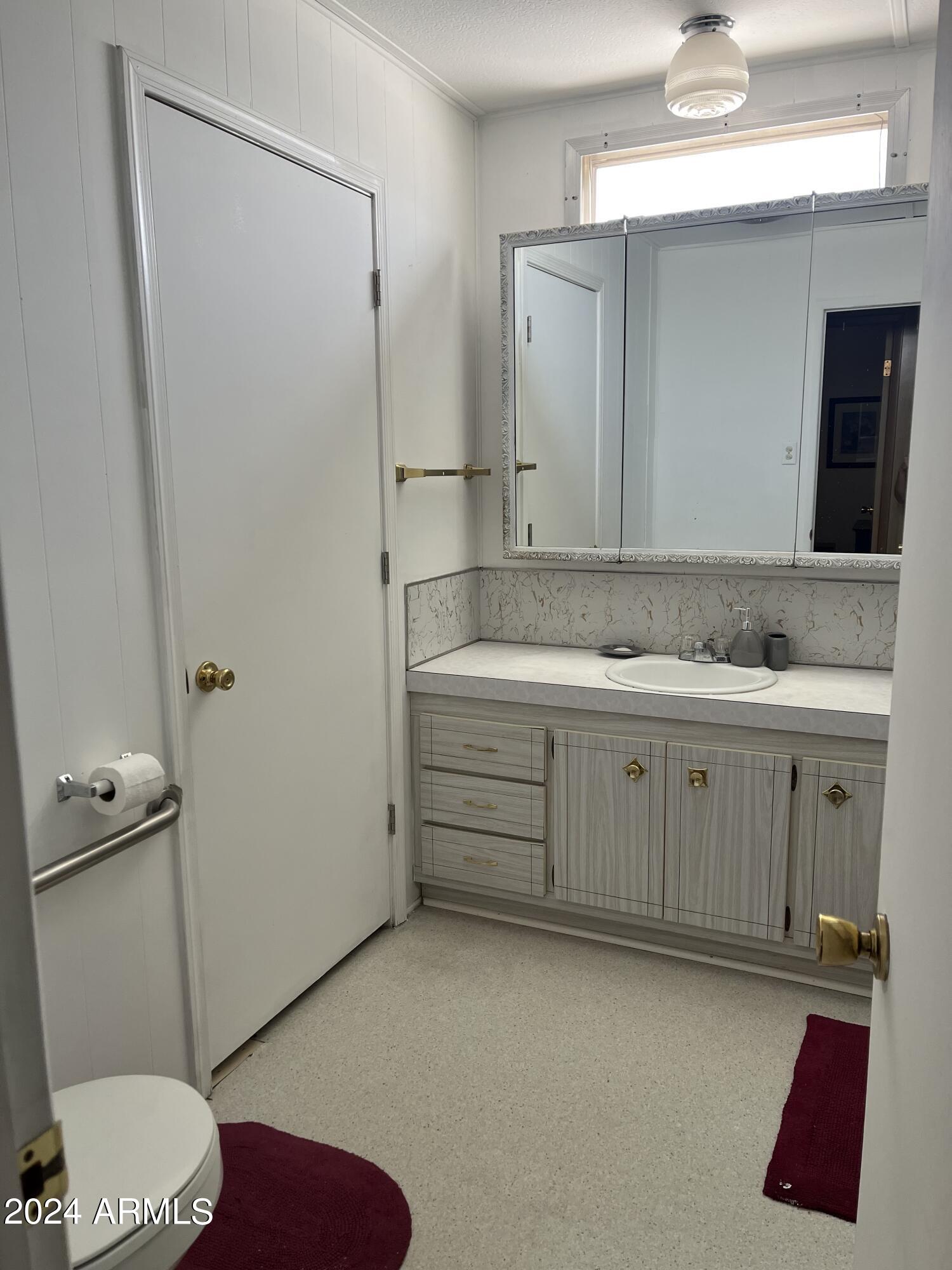 2460 East Main Street, Unit F2 Mesa, AZ 85213 - Photo 14 of 17 a bathroom with a sink and a mirror