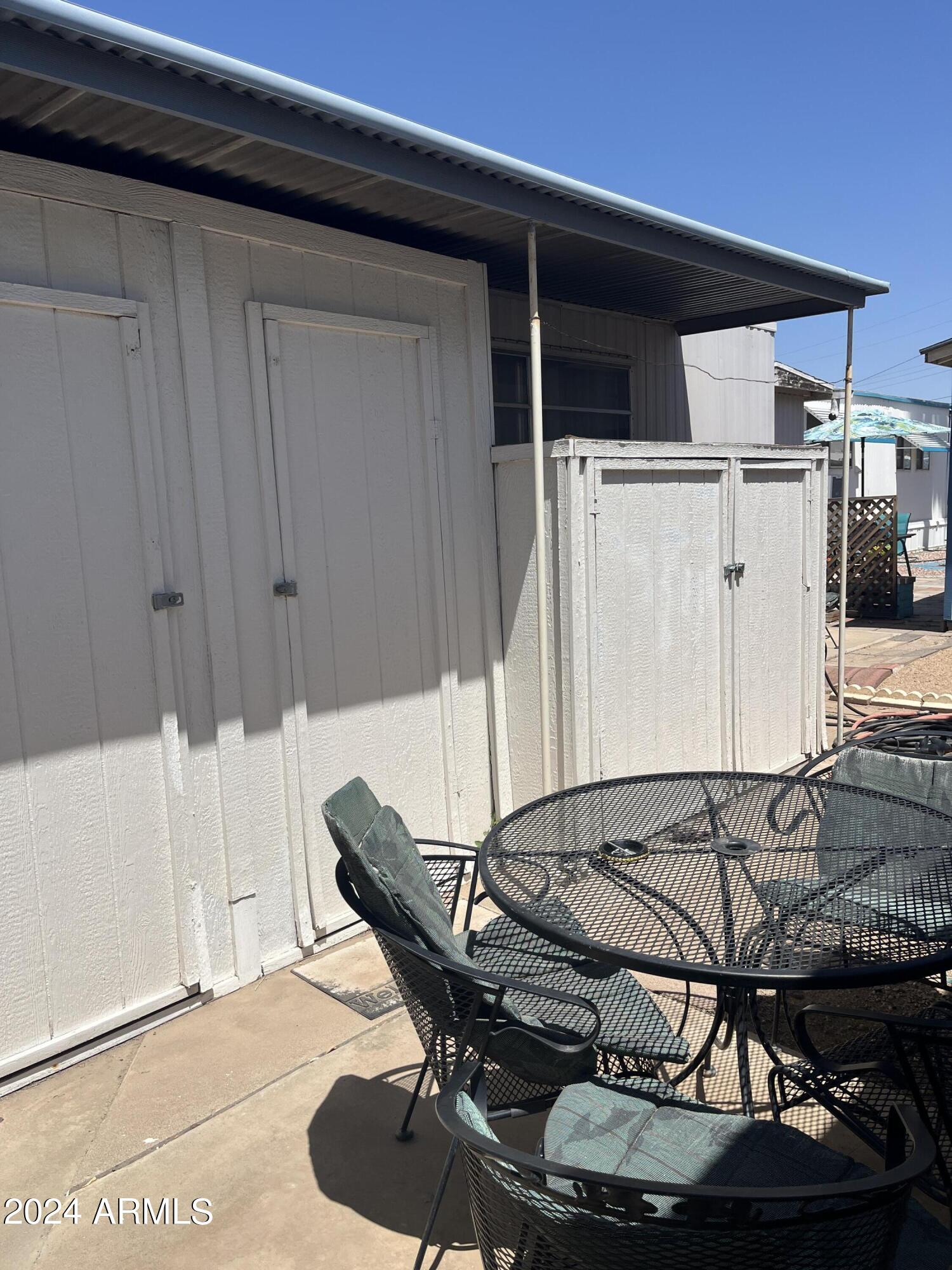 2460 East Main Street, Unit F2 Mesa, AZ 85213 - Photo 16 of 17 a room with wooden furniture and a table