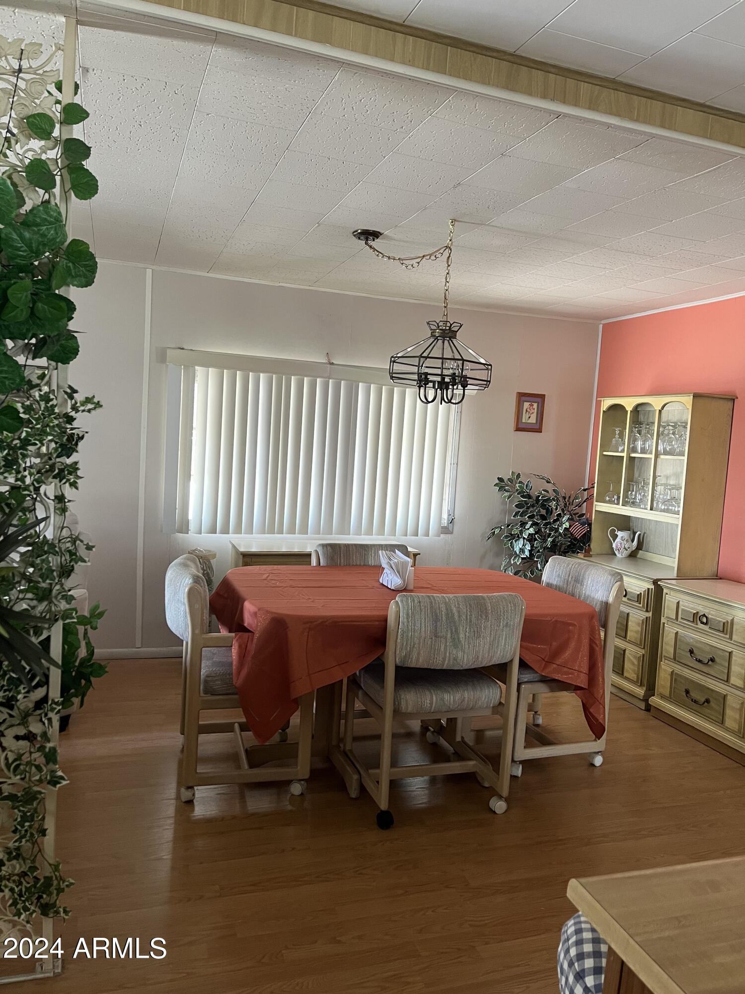 2460 East Main Street, Unit F2 Mesa, AZ 85213 - Photo 2 of 17 a dining room with furniture and wooden floor