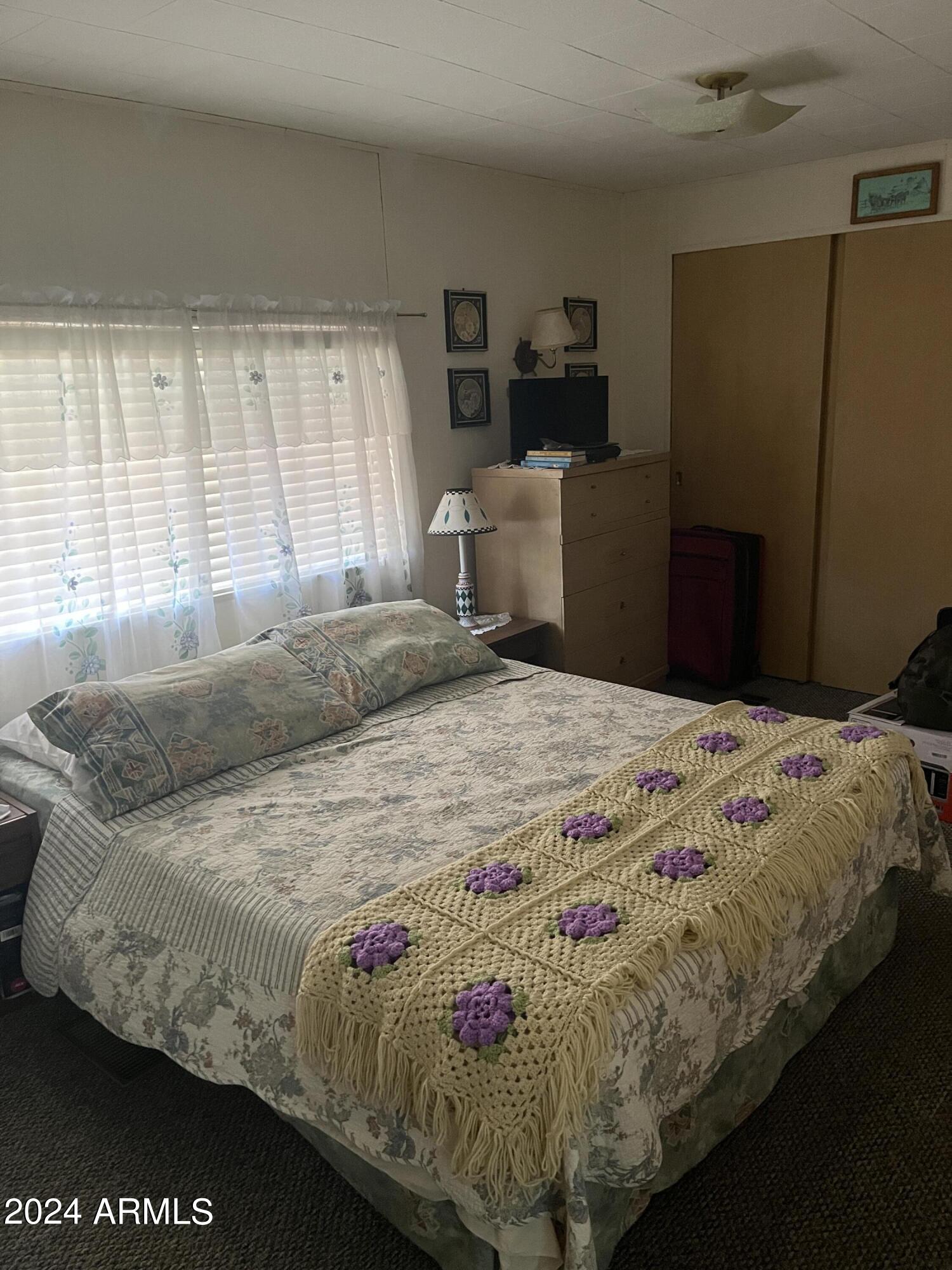 2460 East Main Street, Unit F2 Mesa, AZ 85213 - Photo 8 of 17 a bedroom with a bed and wooden floor