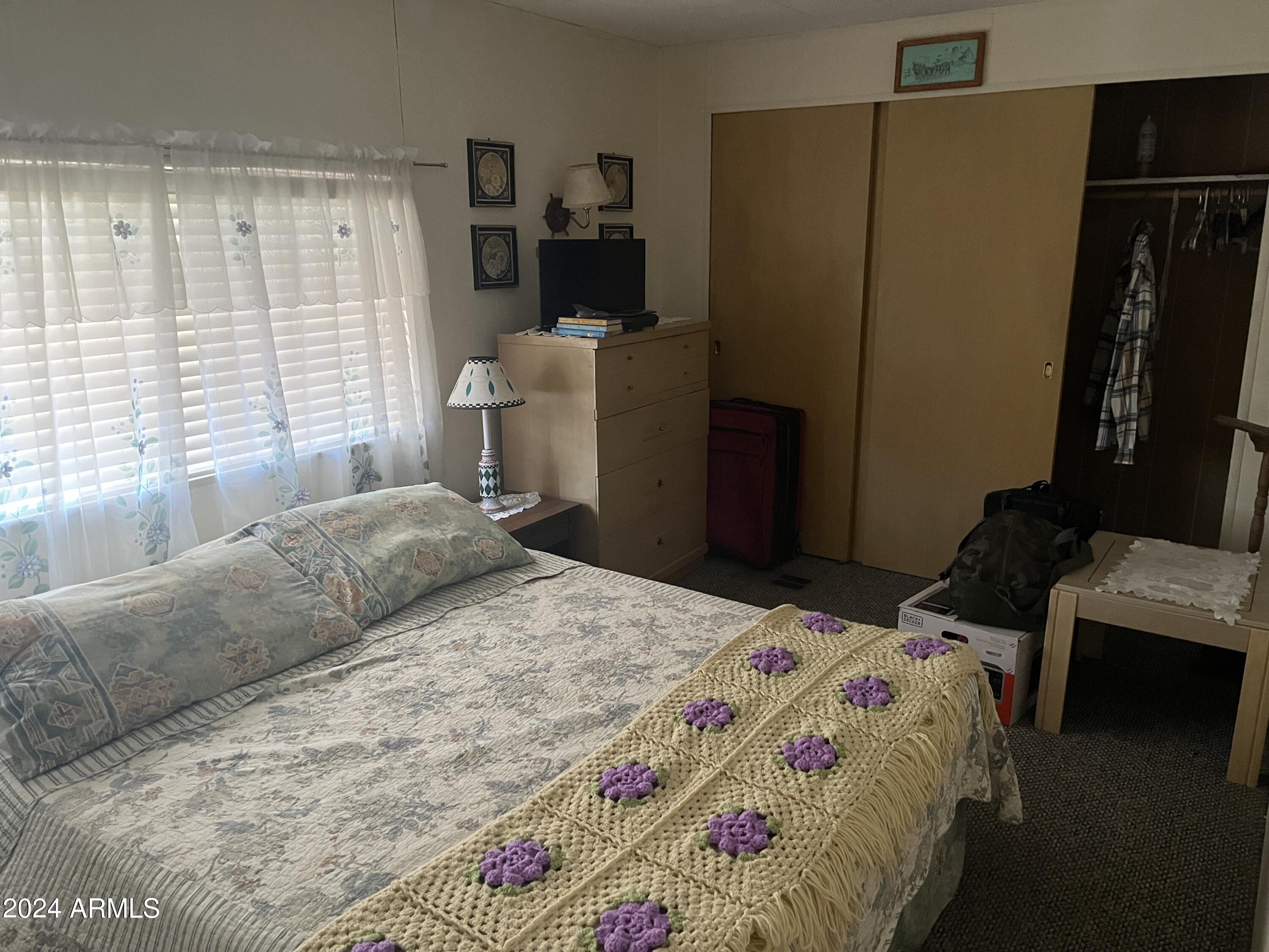 2460 East Main Street, Unit F2 Mesa, AZ 85213 - Photo 9 of 17 a bedroom with a bed and wooden floor