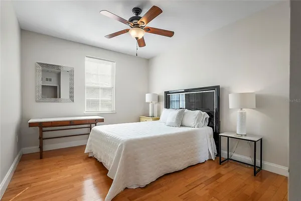 a bedroom with a bed and a chandelier