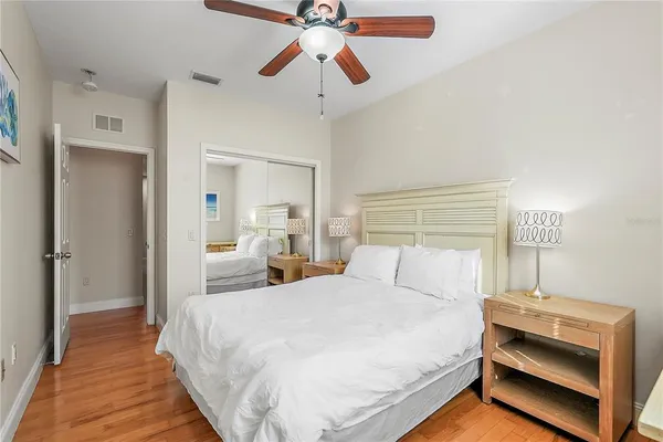 a bedroom with a bed and ceiling fan