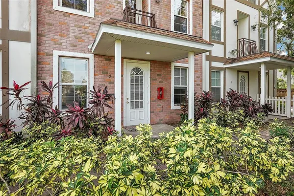 front view of a brick house with a large window