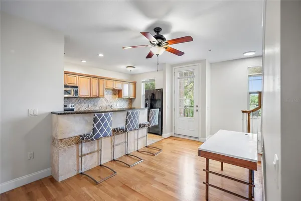 a view of kitchen and hall with wooden floor