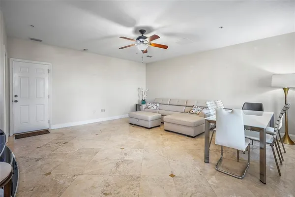 a view of a livingroom with furniture and a ceiling fan