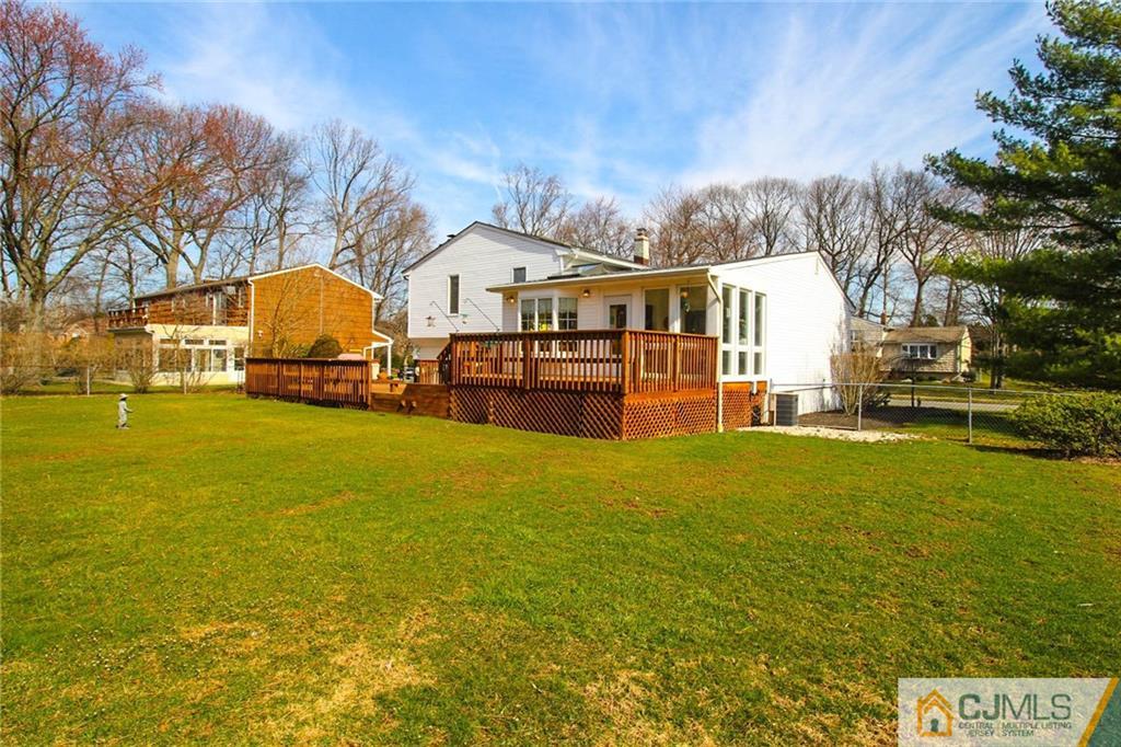 11 Butler Road Edison, NJ 08820 - Photo 22 of 25 a view of a large pool with lawn chairs and a large tree