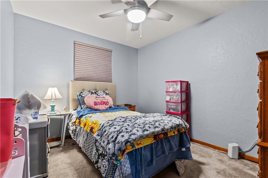 4 Harter Circle Pittsburgh, PA 15236 - Photo 15 of 29 a bedroom with a bed and a chandelier