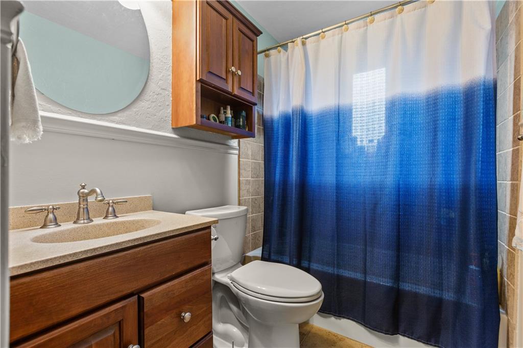 4 Harter Circle Pittsburgh, PA 15236 - Photo 16 of 29 a bathroom with a sink a toilet and shower curtain