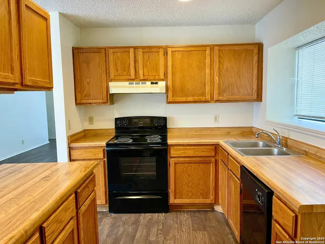 a kitchen with a stove a sink and a microwave