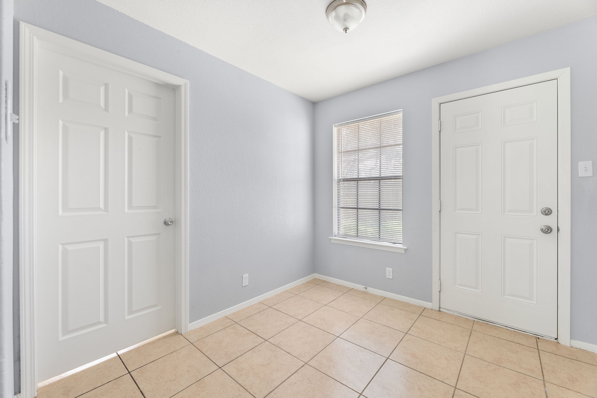 3802 Foust Trail, Unit A Georgetown, TX 78628 - Photo 7 of 34 A well-lit entry welcomes with durable tile flooring and two distinct doorways.