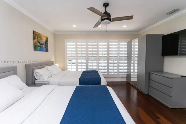 a bedroom with a bed and a large window