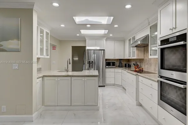 a kitchen with cabinets and stainless steel appliances