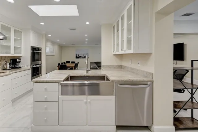 a kitchen with cabinets and stainless steel appliances