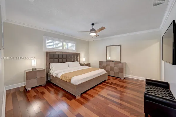 a bedroom with a bed and wooden floor