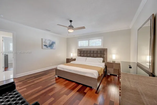 a bedroom with furniture a flat screen tv and a fireplace