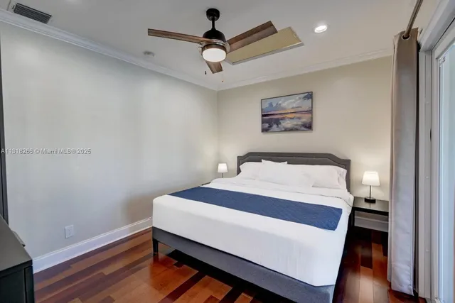 a bedroom with a bed and a wall painting