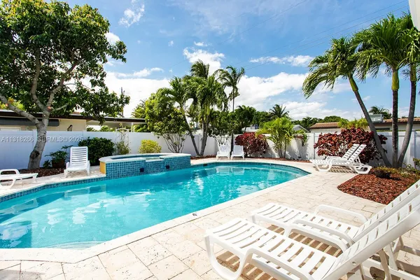a view of a backyard with a garden and seating area
