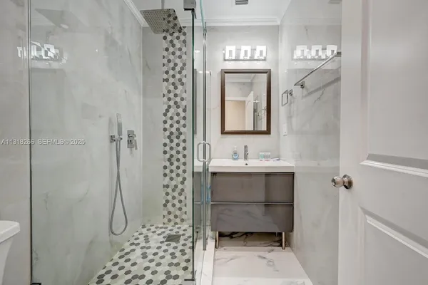 a bathroom with a toilet sink shower and mirror