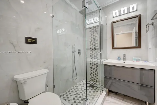 a bathroom with a bathtub shower sink mirror and toilet
