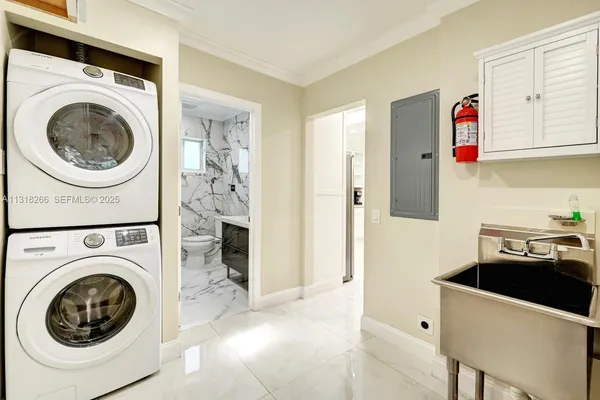 a utility room with sink dryer and washer