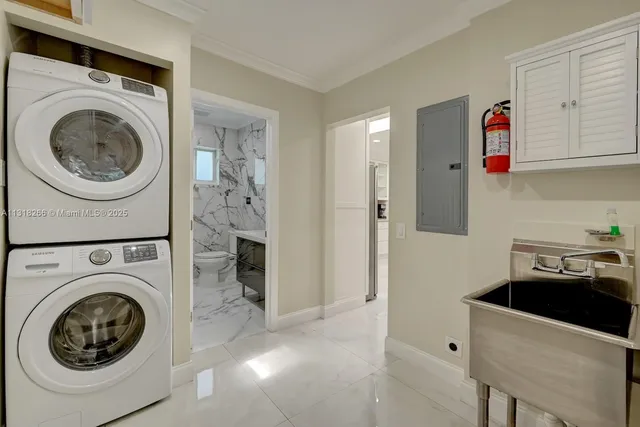 a utility room with sink dryer and washer