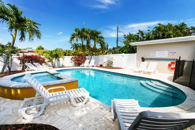 a view of swimming pool with a lounge chairs