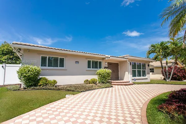 a bedroom with two beds and a flat screen tv