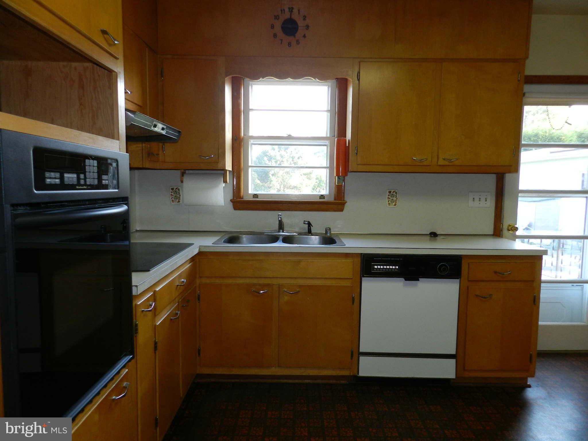 7135 Bowers Road Frederick, MD 21702 - Photo 11 of 30 a kitchen with granite countertop cabinets stainless steel appliances and a window