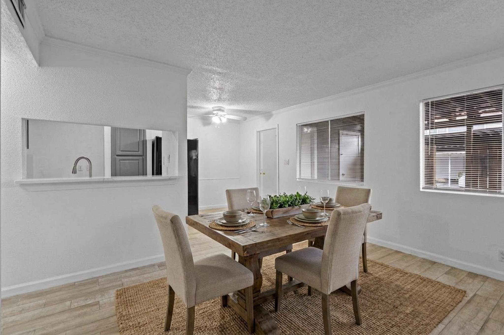 11002 Hammerly Boulevard, Unit 61 Houston, TX 77043 - Photo 5 of 12 a view of a dining room with furniture and wooden floor
