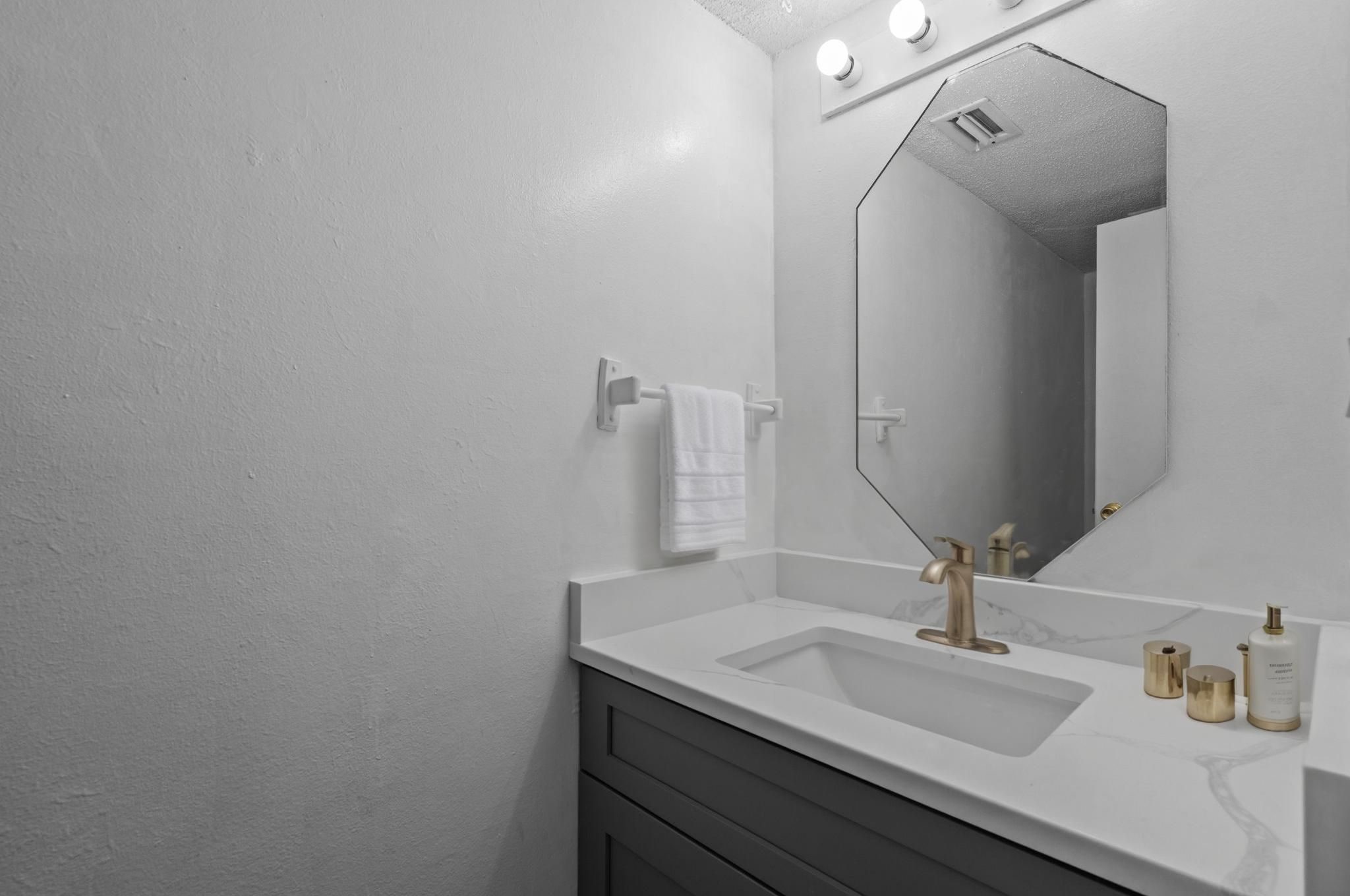 11002 Hammerly Boulevard, Unit 61 Houston, TX 77043 - Photo 9 of 12 a bathroom with a sink and a mirror