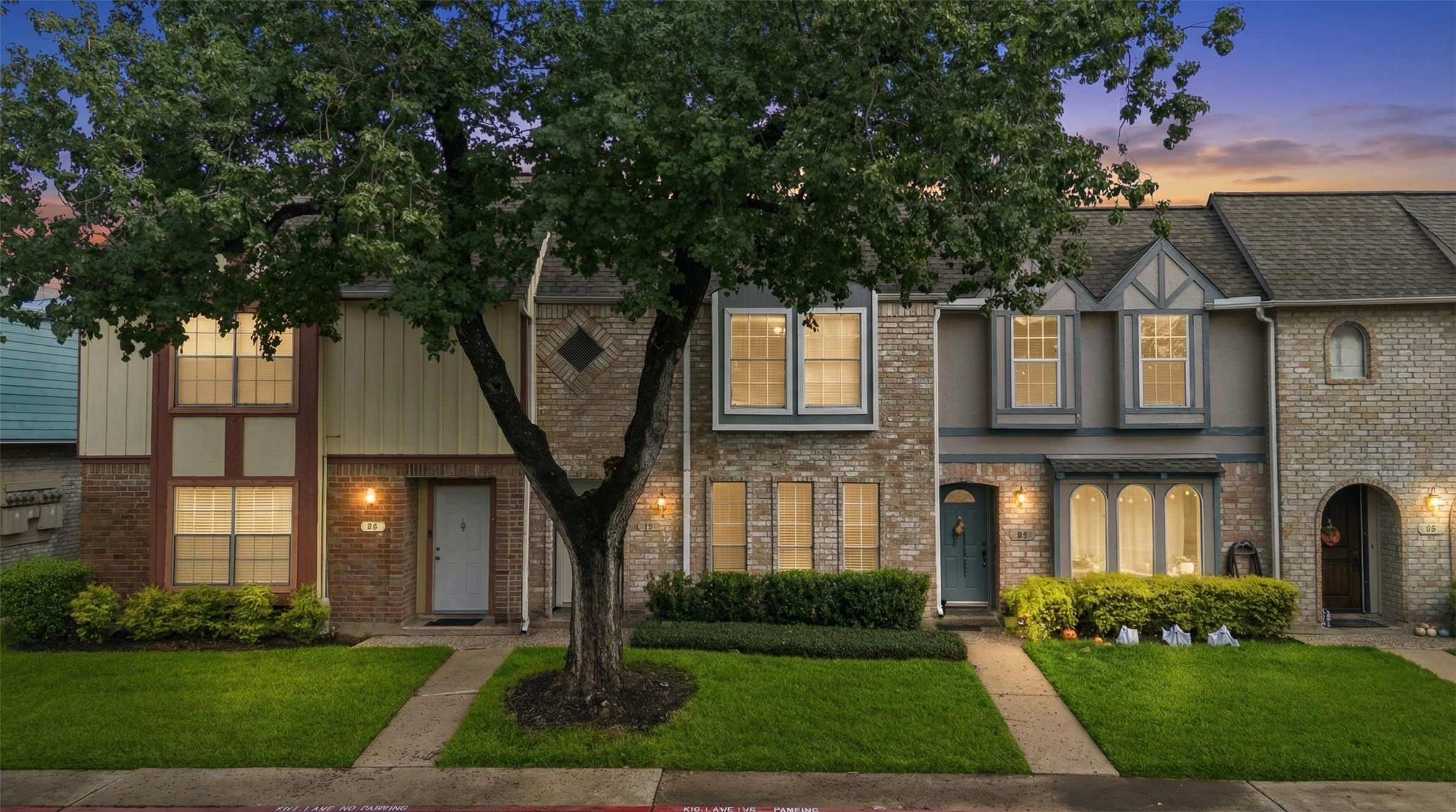 11002 Hammerly Boulevard, Unit 61 Houston, TX 77043 - Photo 10 of 12 a front view of a house with a yard