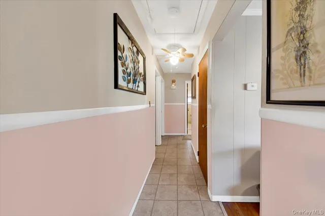 staircase with white walls and door