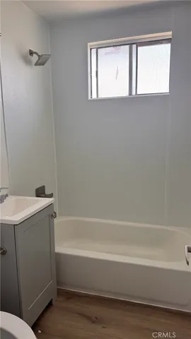 a bathroom with a bathtub and a sink