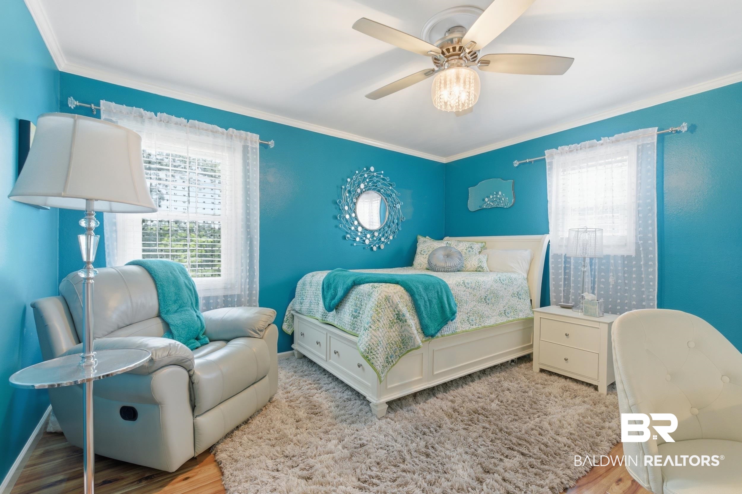 51620 Robert White Road Bay Minette, AL 36507 - Photo 61 of 81 Well-lit room featuring vibrant wall color, crown molding, a ceiling fan with integrated lighting, wood-finish flooring, and a large window