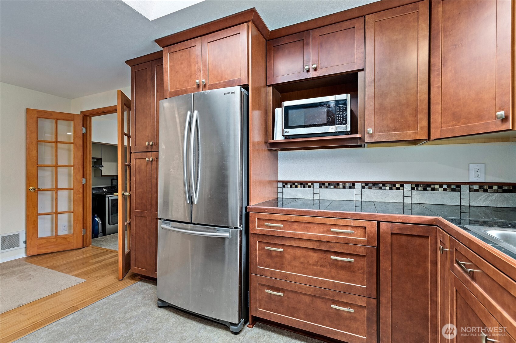 4813 150th Place Southwest Edmonds, WA 98026 - Photo 12 of 28 a kitchen with granite countertop stainless steel appliances and wooden cabinets