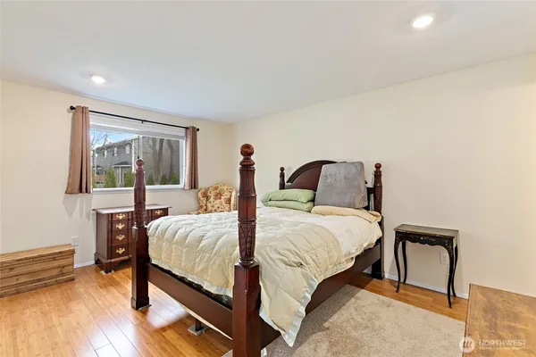 a bedroom with a bed and a large window