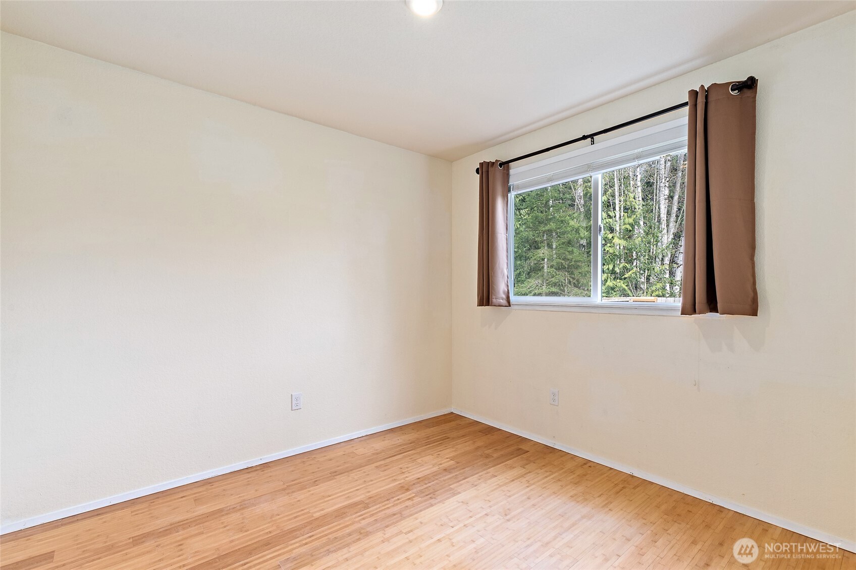 4813 150th Place Southwest Edmonds, WA 98026 - Photo 20 of 28 a view of an empty room with wooden floor and a window
