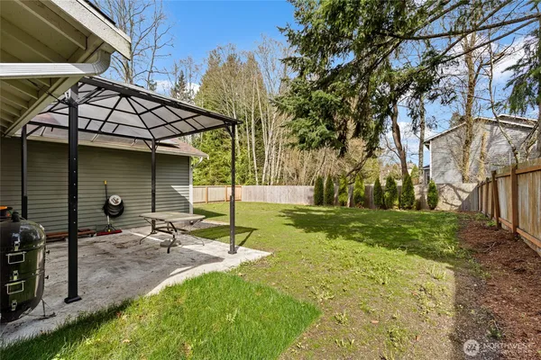 a view of a backyard with plants and patio