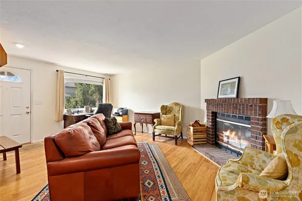 a living room with furniture a couch and large window