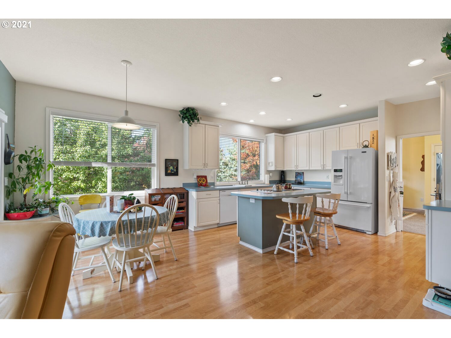 16980 Southwest Ferrelo Place Beaverton, OR 97007 - Photo 15 of 32 a dining room with stainless steel appliances kitchen island granite countertop a dining table chairs and granite counter tops