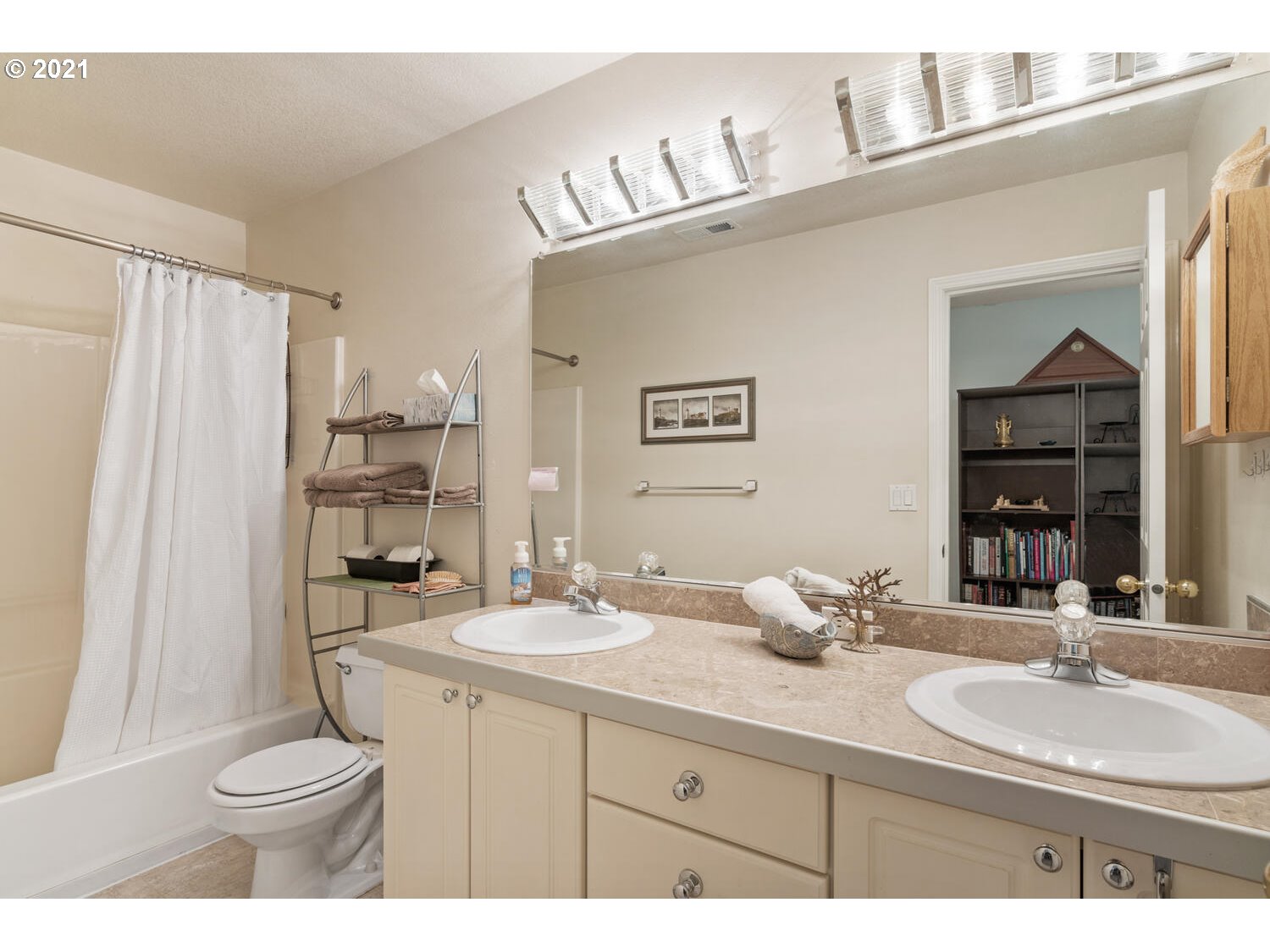 16980 Southwest Ferrelo Place Beaverton, OR 97007 - Photo 22 of 32 a bathroom with a double vanity sink toilet and a mirror