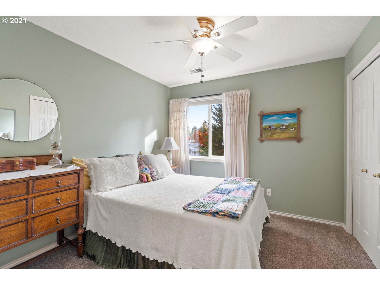 16980 Southwest Ferrelo Place Beaverton, OR 97007 - Photo 23 of 32 a bedroom with a bed and a chandelier