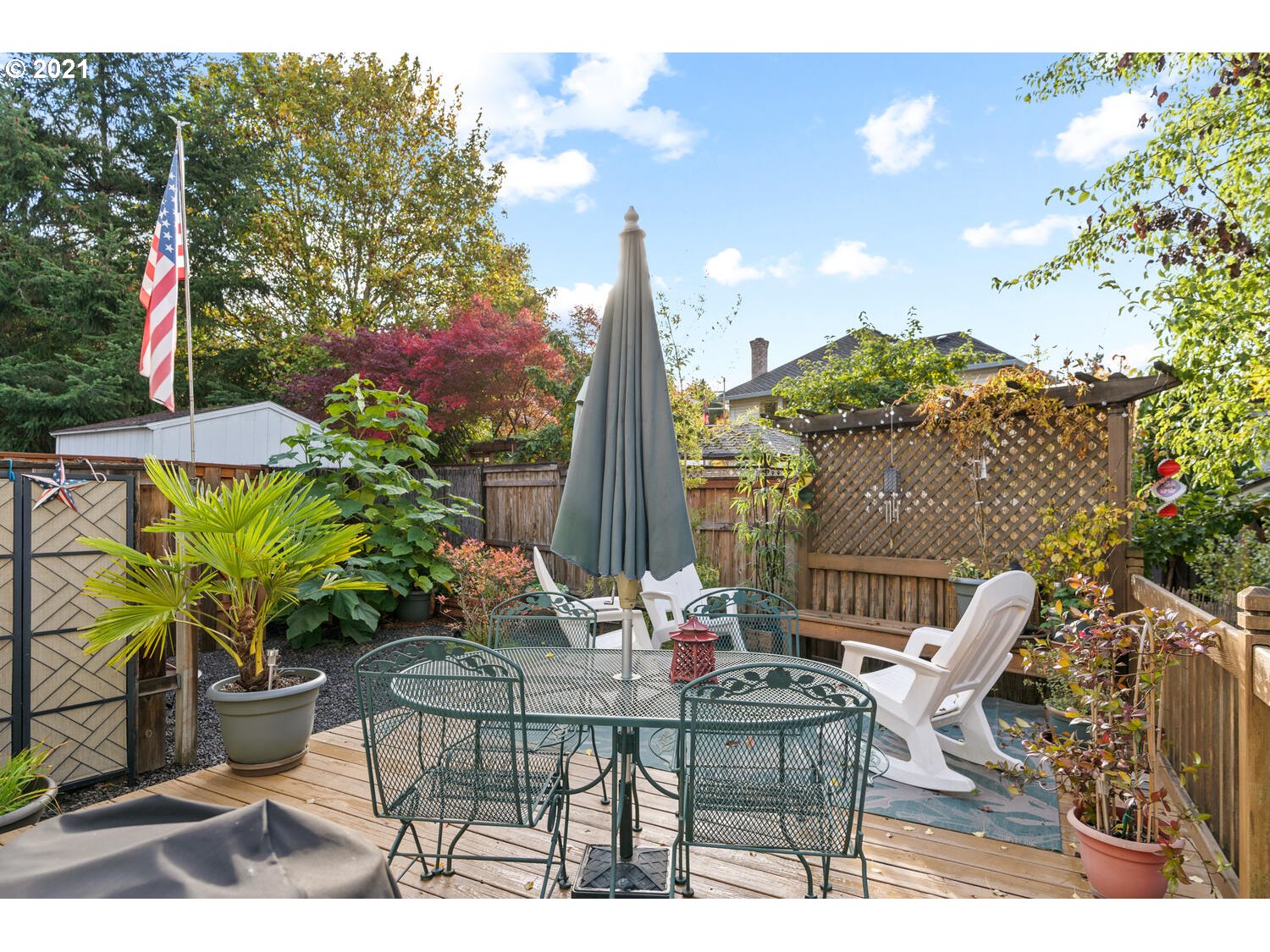 16980 Southwest Ferrelo Place Beaverton, OR 97007 - Photo 27 of 32 a view of a patio with table and chairs potted plants and floor to ceiling window