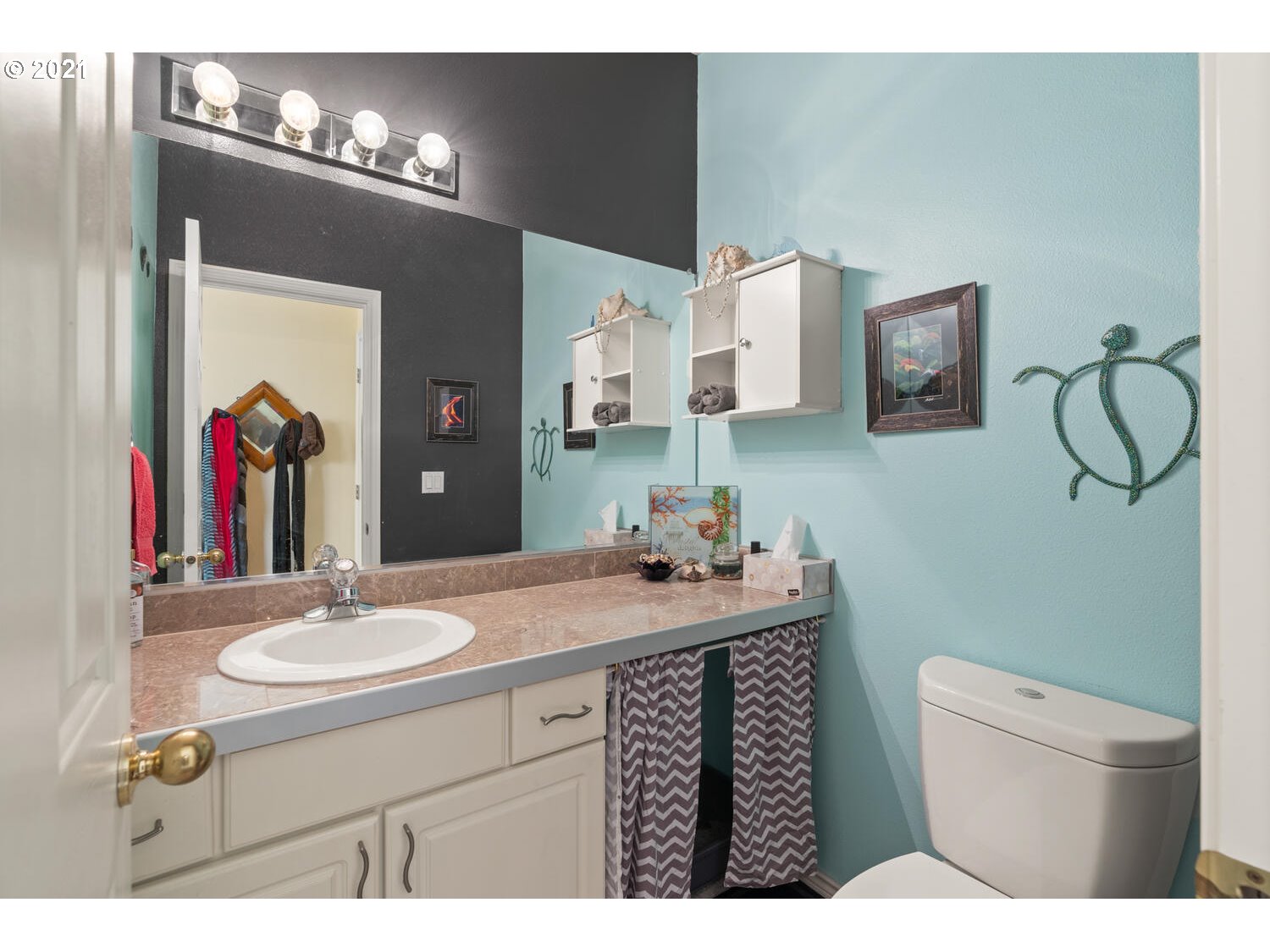 16980 Southwest Ferrelo Place Beaverton, OR 97007 - Photo 10 of 32 a bathroom with a sink vanity mirror and toilet