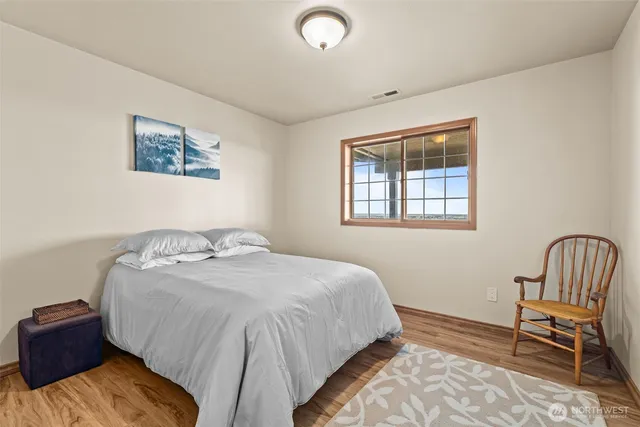 a bathroom with a granite countertop sink toilet and mirror