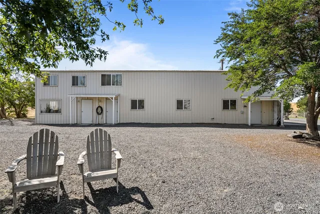 a living room with furniture a couch and paintings on the wall
