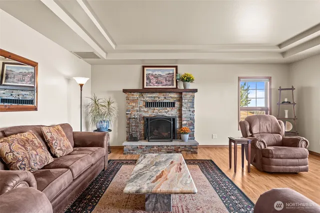 a spacious bedroom with a bed and wooden floor